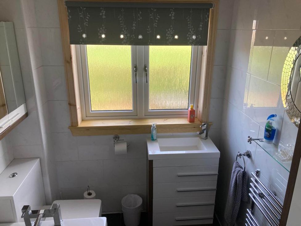 A bathroom with a sink and toilet at Spacious family base with garden near Loch Ness