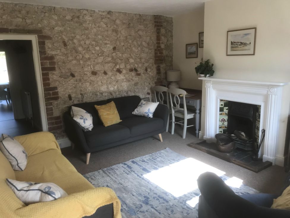 A living room with sofas and a fireplace at tbc