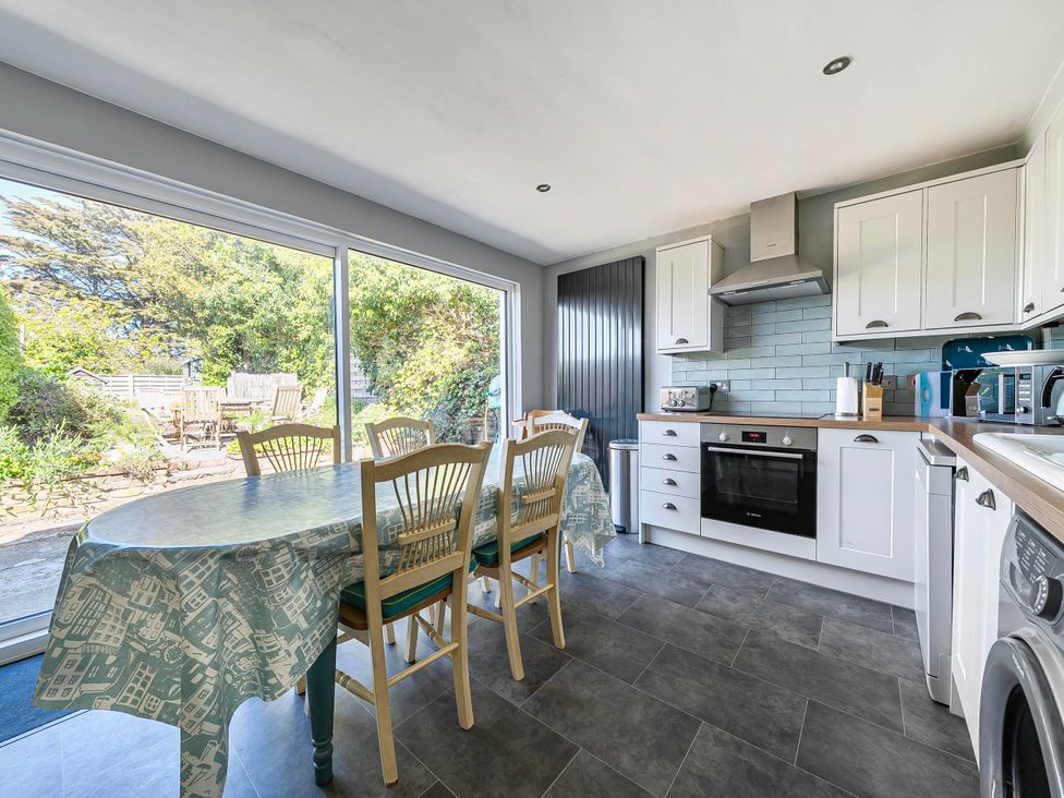 A kitchen with a table and chairs at Coastal cottage near harbour, beach and pubs, Brancaster