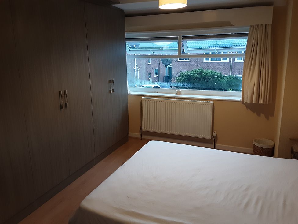 A bedroom with a wardrobe and a bed at tbc in 