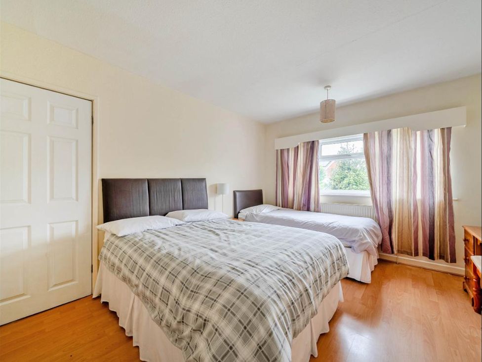 A bedroom with two beds next to a window at Village retreat with canal walk into Chester in Christleton