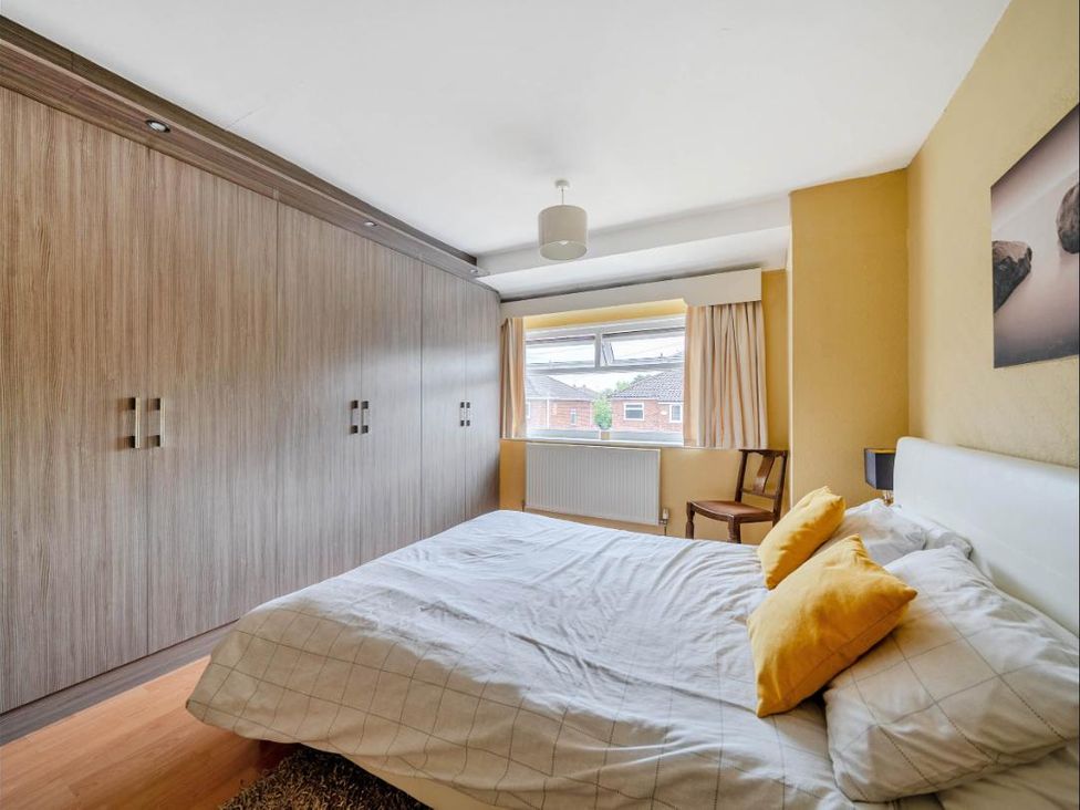 A bedroom with a bed and wardrobe at Village retreat with canal walk into Chester, Christleton