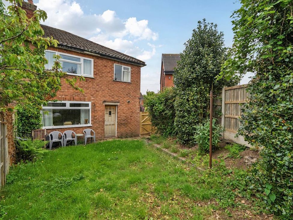A garden with chairs and grass at Village retreat with canal walk into Chester in Christleton