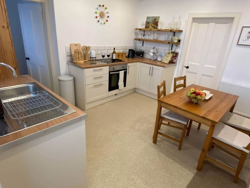 A kitchen with a table and chairs at Pet-friendly coastal flat with fire pit and views, Newburgh, Fife