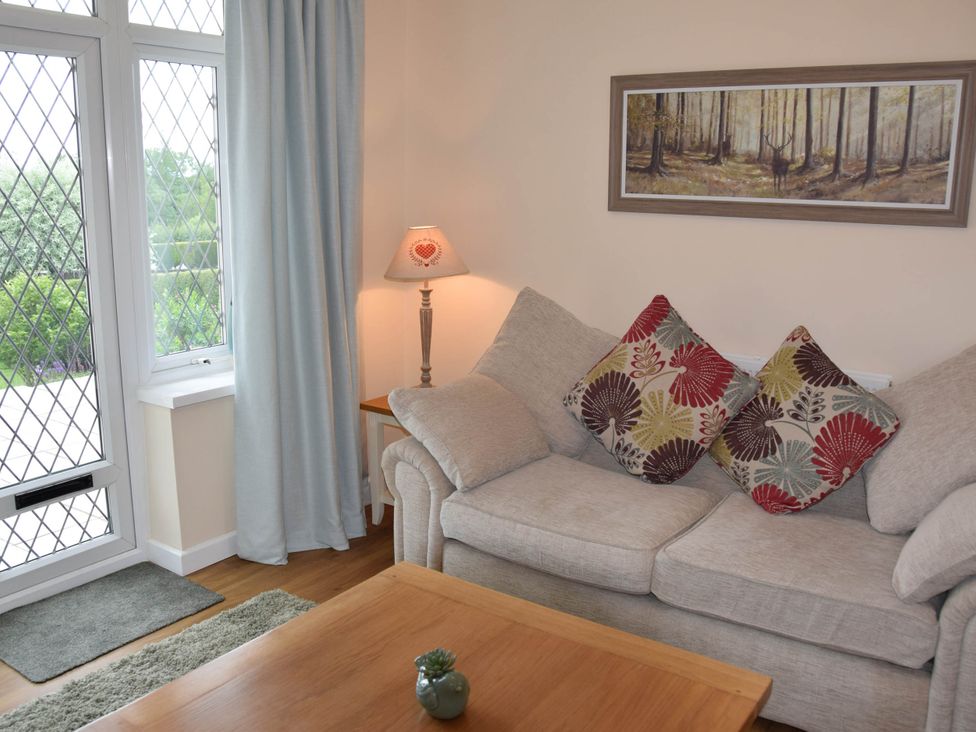 A living room with a sofa and lamp at tbc