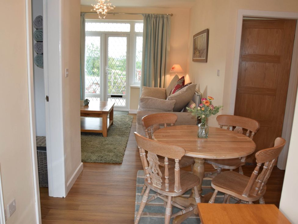 A living room with a table and chairs at tbc