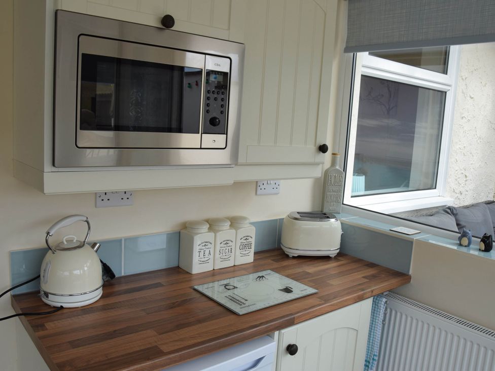 A kitchen with kitchen appliances and canisters at tbc
