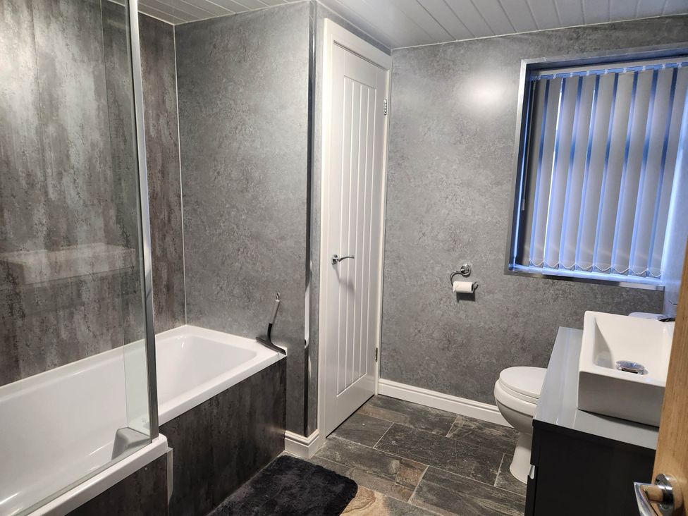 A bathroom featuring a bathtub, shower, toilet, and sink at tbc