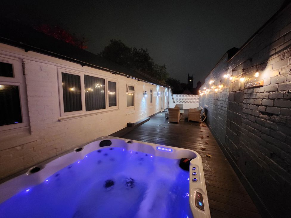A hot tub with lighting on a patio at tbc 