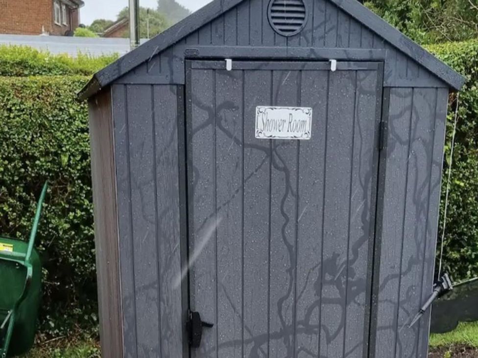A shed with a sign that says Shower Room at tbc 