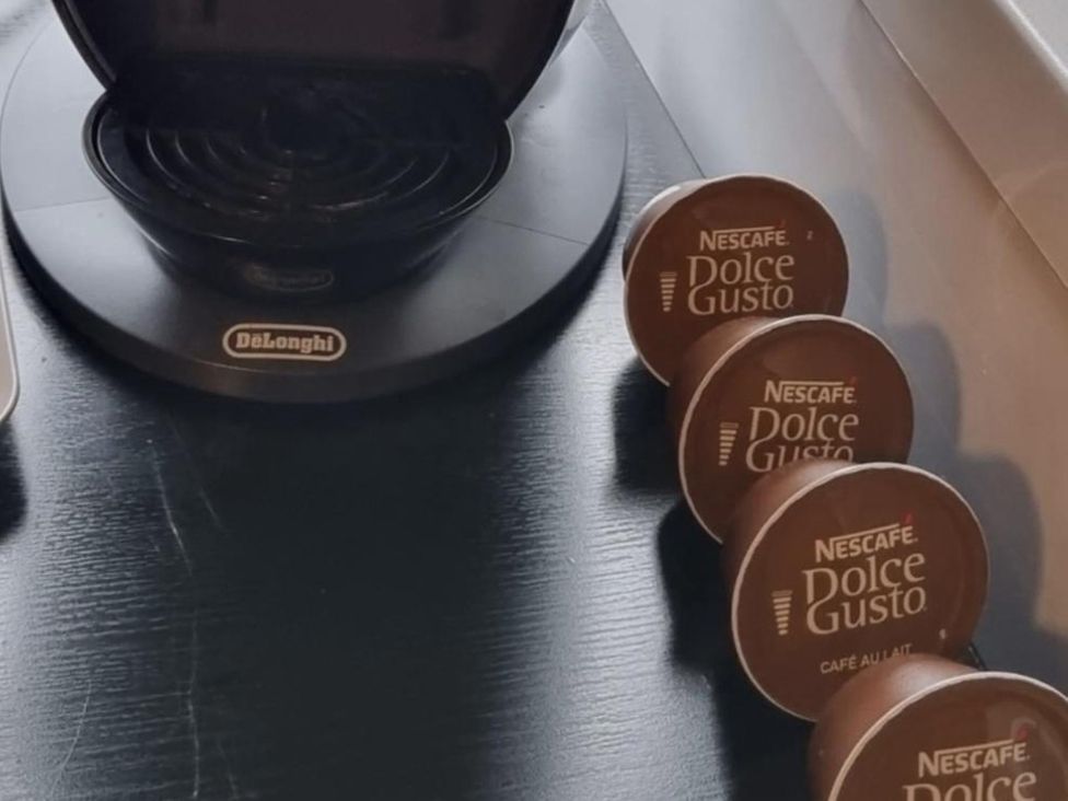 A coffee machine with coffee pods at tbc