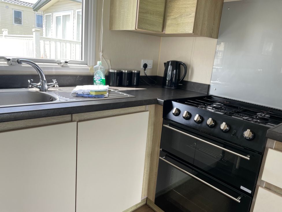 A kitchen with a sink and stove at tbc 