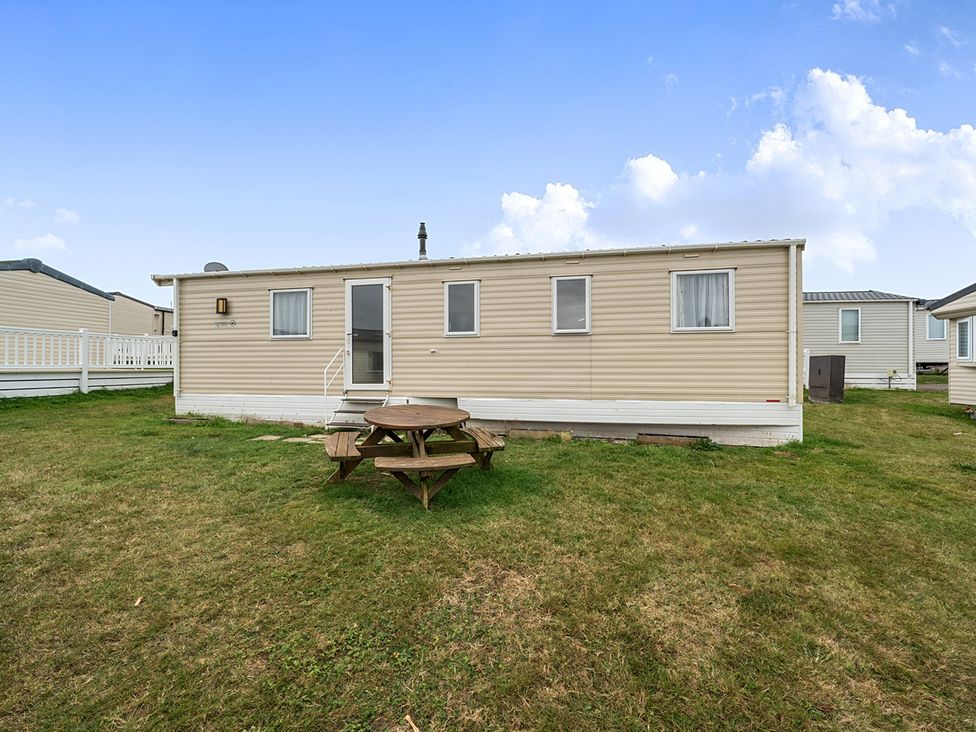 A caravan with a picnic table outside at Pet-friendly lodge near Fistral Beach, Fistral Beach, Newquay