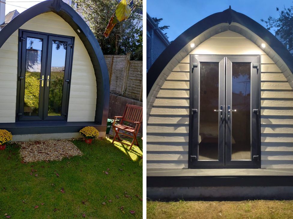 A garden pod with a door and chair at tbc 