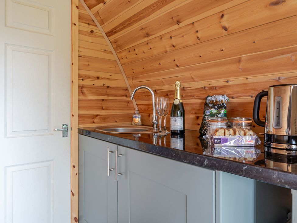 A kitchen area with a sink and a kettle at Peaceful pod with bay views, walk to 3 beaches St Ives