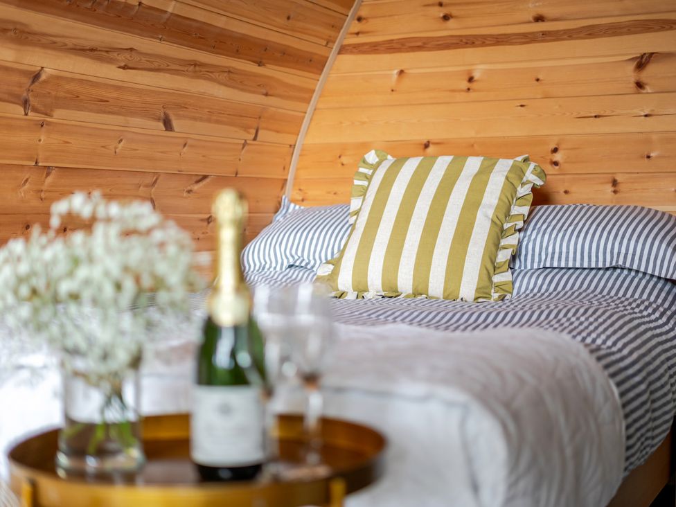 A bedroom with a bed and decorative items at Peaceful pod with bay views, walk to 3 beaches in St Ives