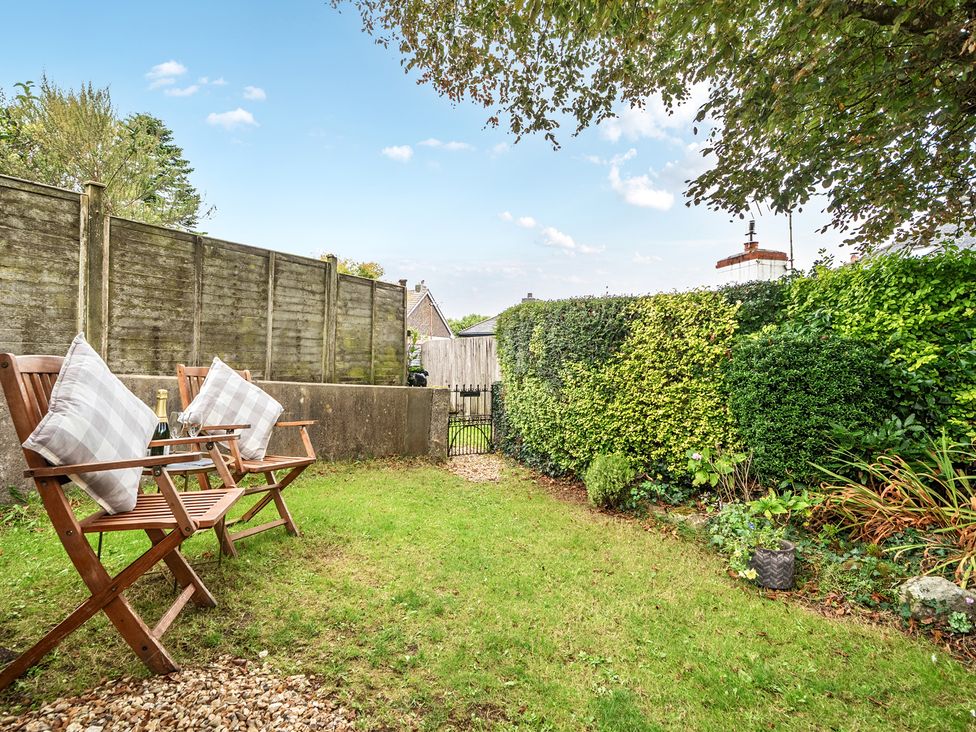 A garden with chairs and cushions at Peaceful pod with bay views, walk to 3 beaches, St Ives