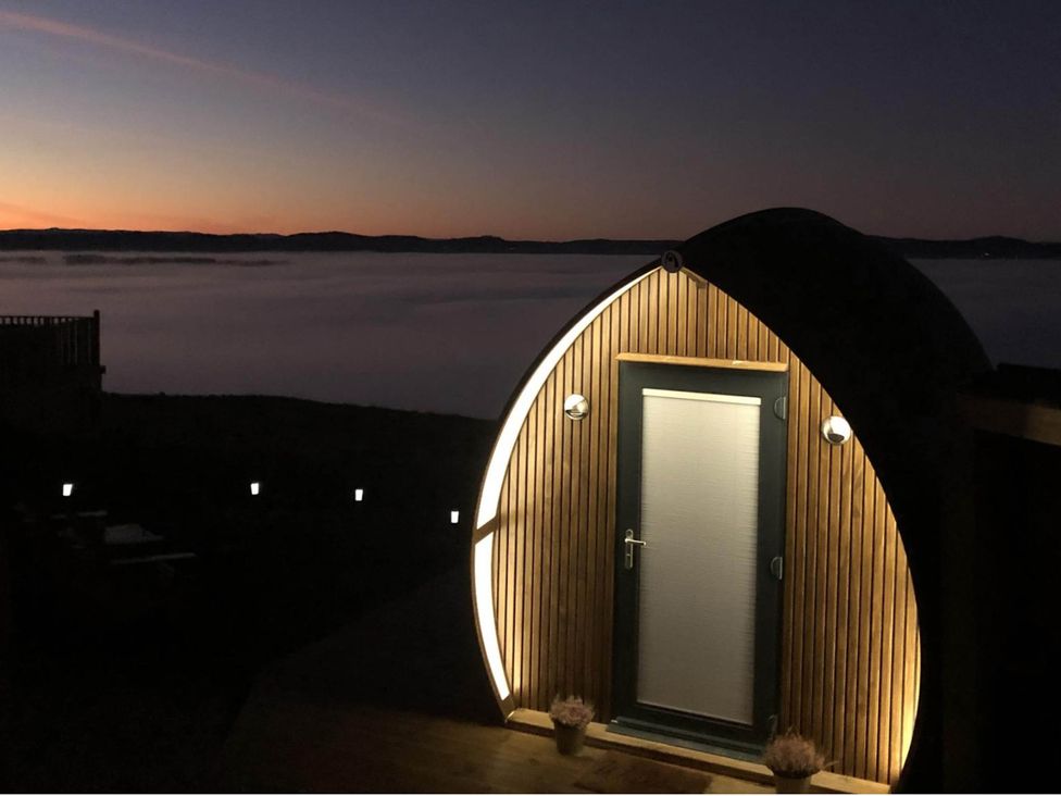 A wooden door structure with lighting at sunset at tbc in 