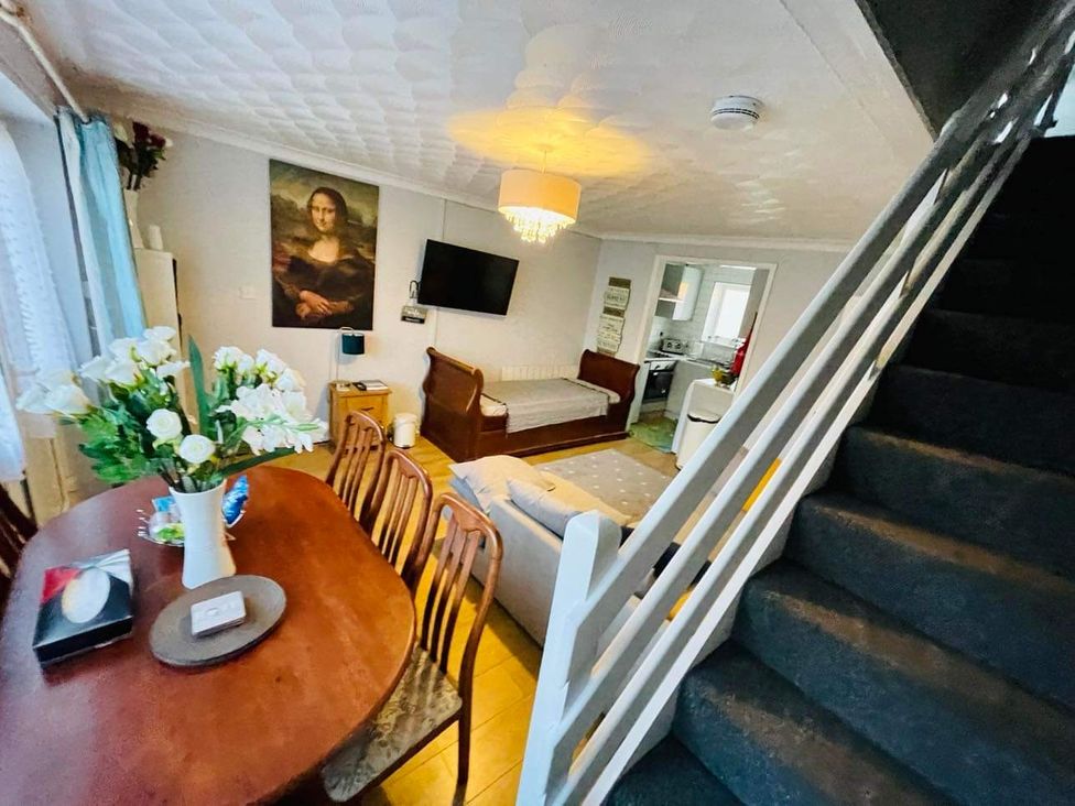 A living room with a dining table and chairs at tbc