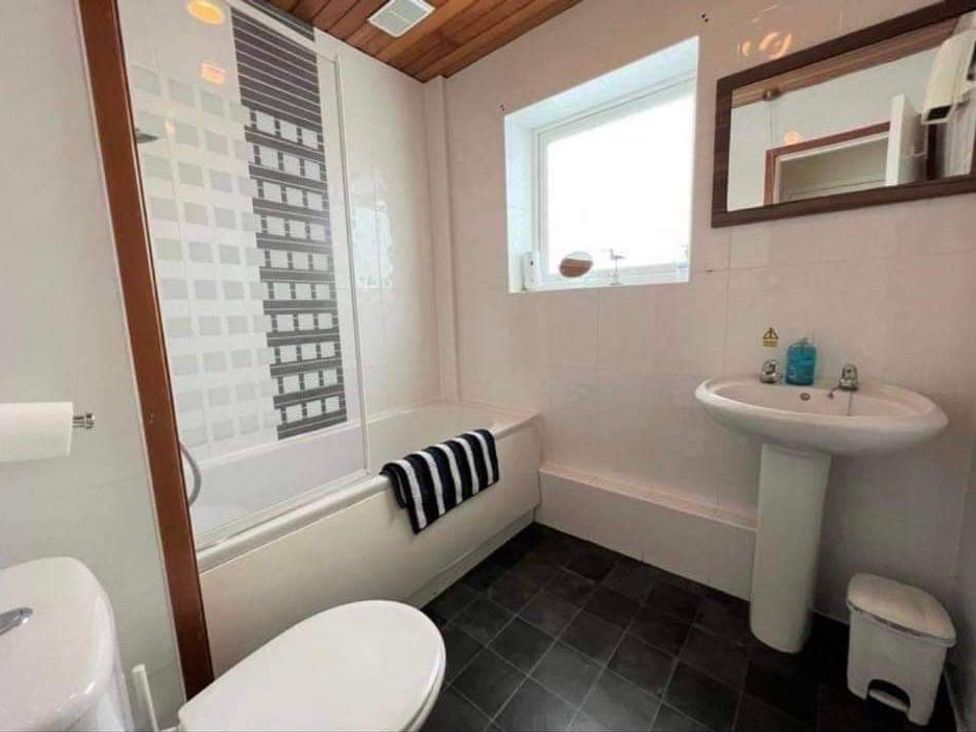 A bathroom with a bathtub, sink and toilet at tbc