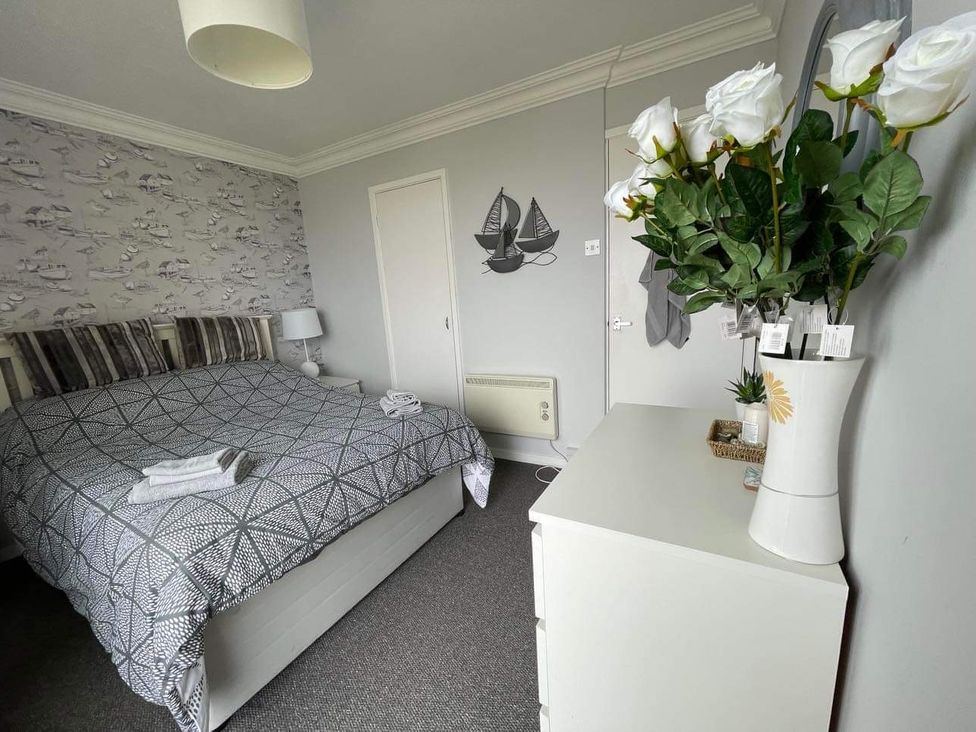 A bedroom with a bed and dresser at tbc 