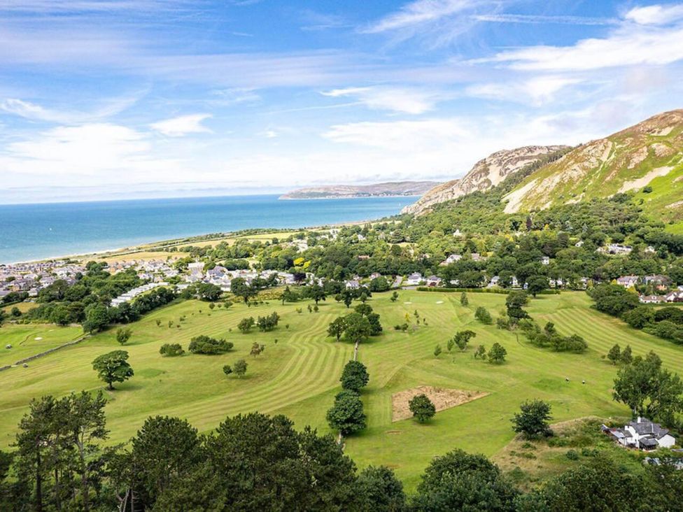 An outdoor view featuring hills, sea, and grassland at tbc 