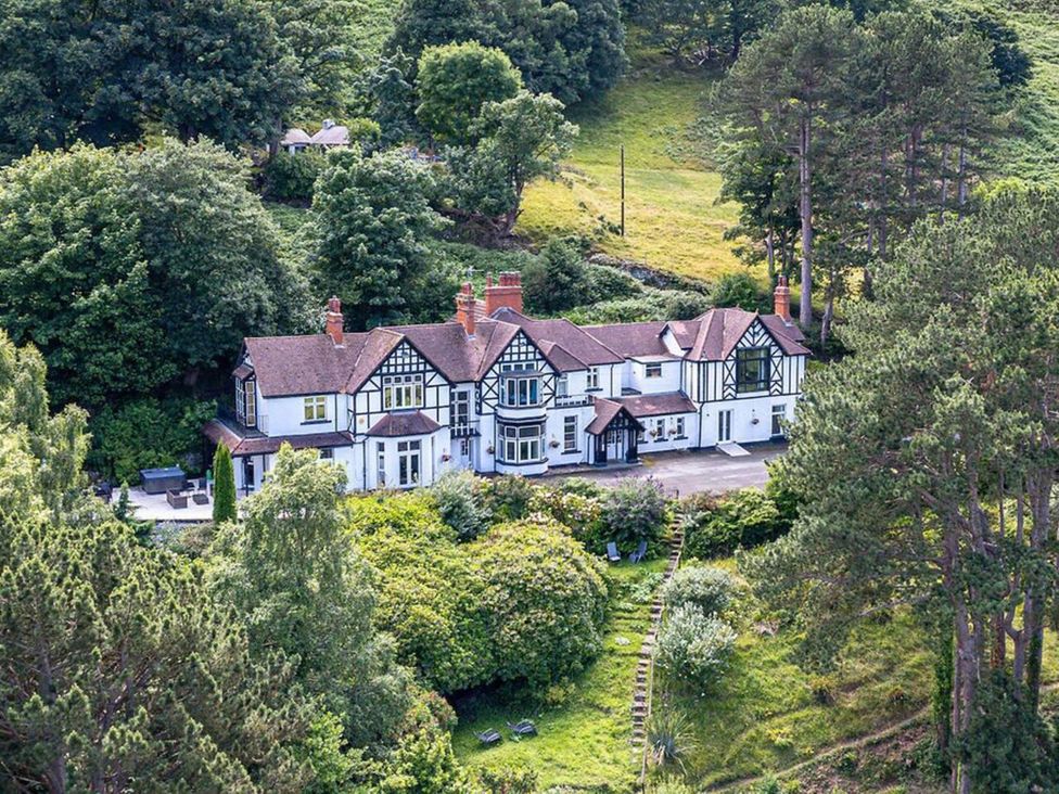 A house with garden and trees at tbc 