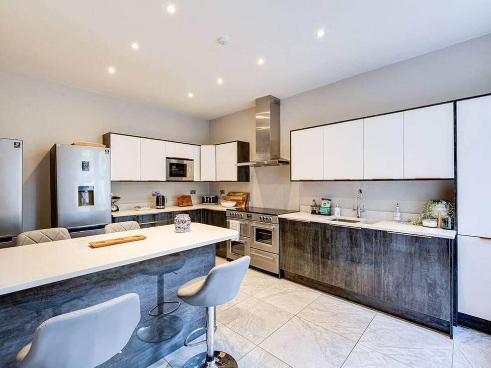 A kitchen with appliances and seating at tbc