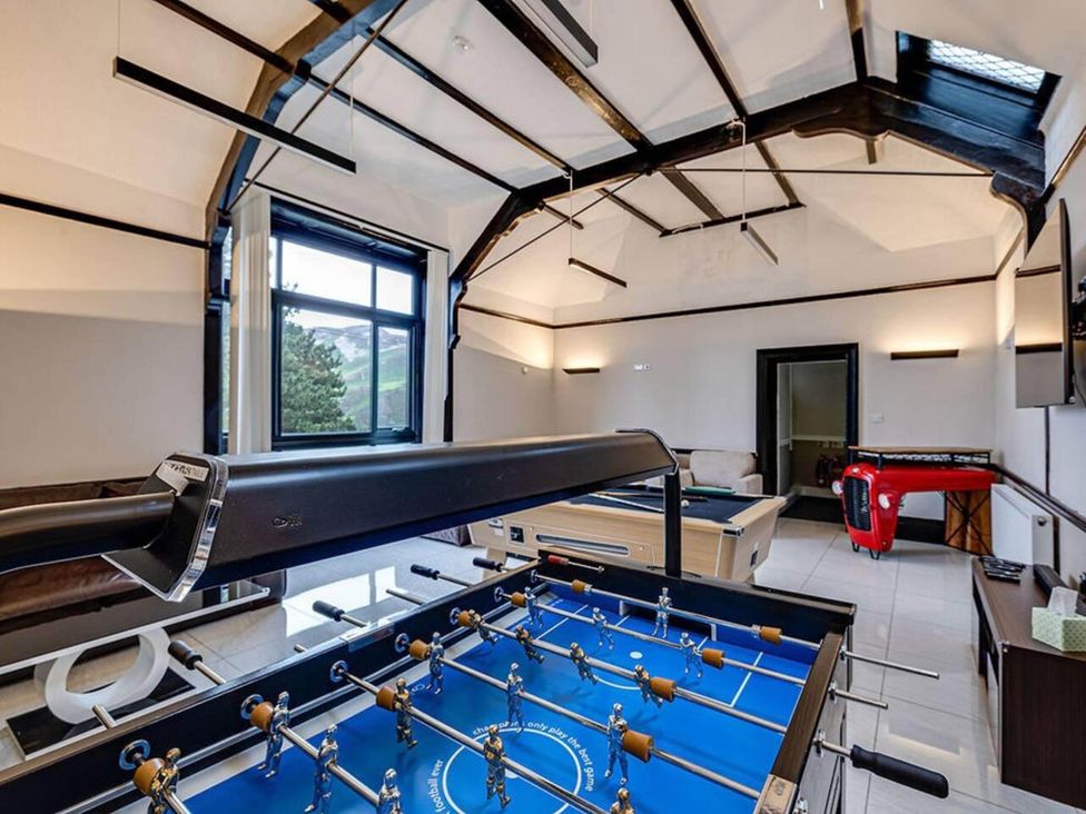 A game room with a foosball table and pool table at The Old Barn in 