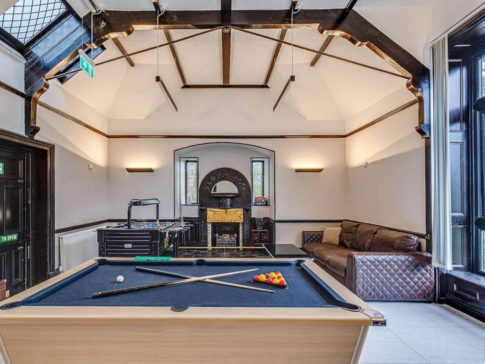 A game room with a pool table and foosball table at tbc 