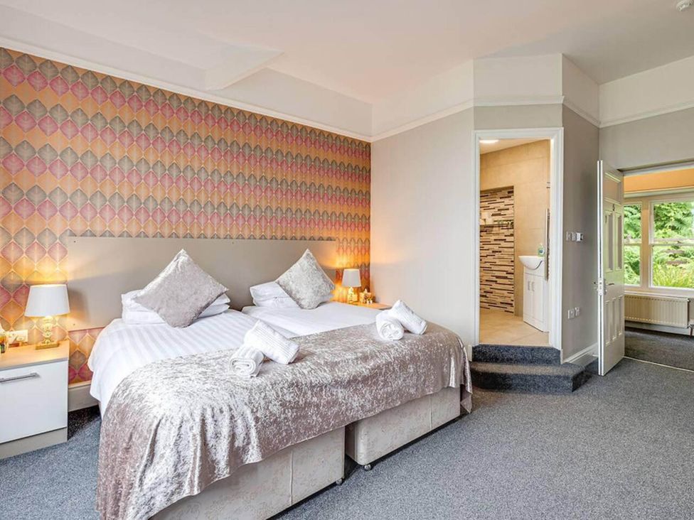 A bedroom with two beds and a bathroom at tbc 