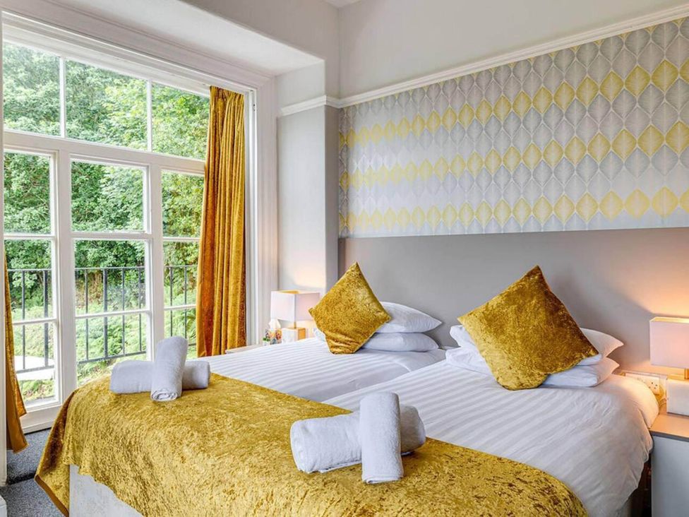 A bedroom with two beds and large windows at tbc in 