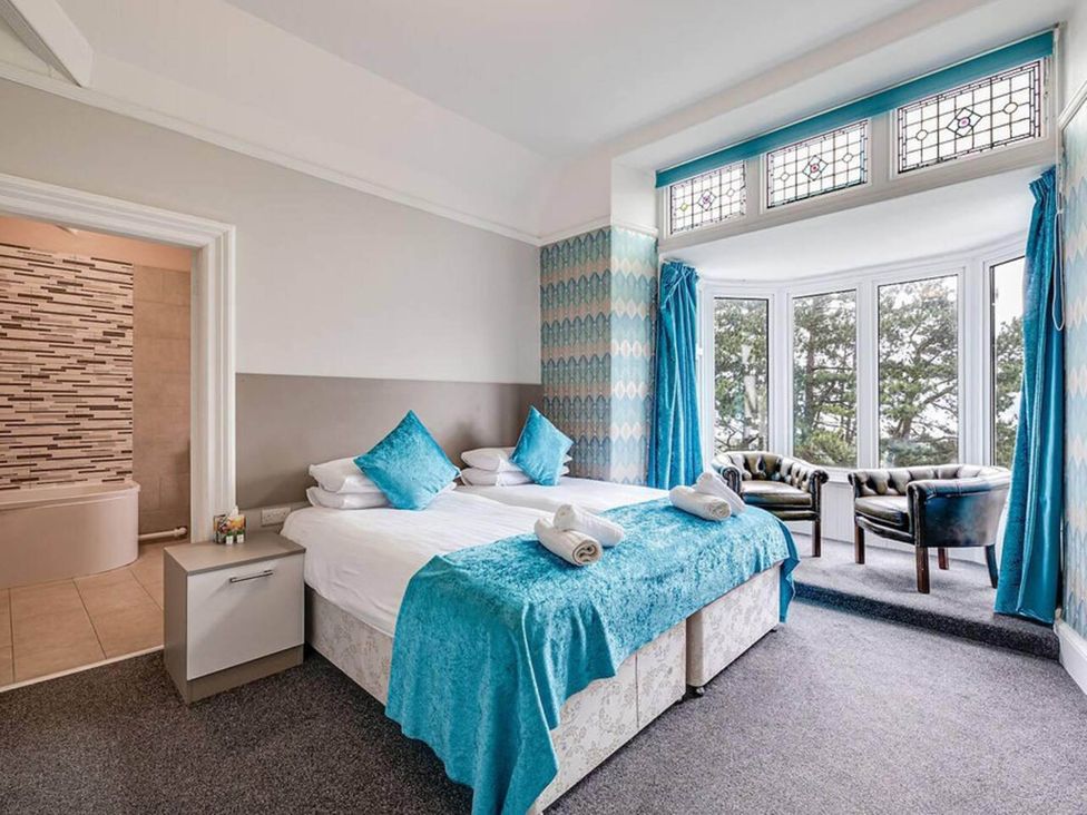 A bedroom with two beds and a seating area at tbc in 