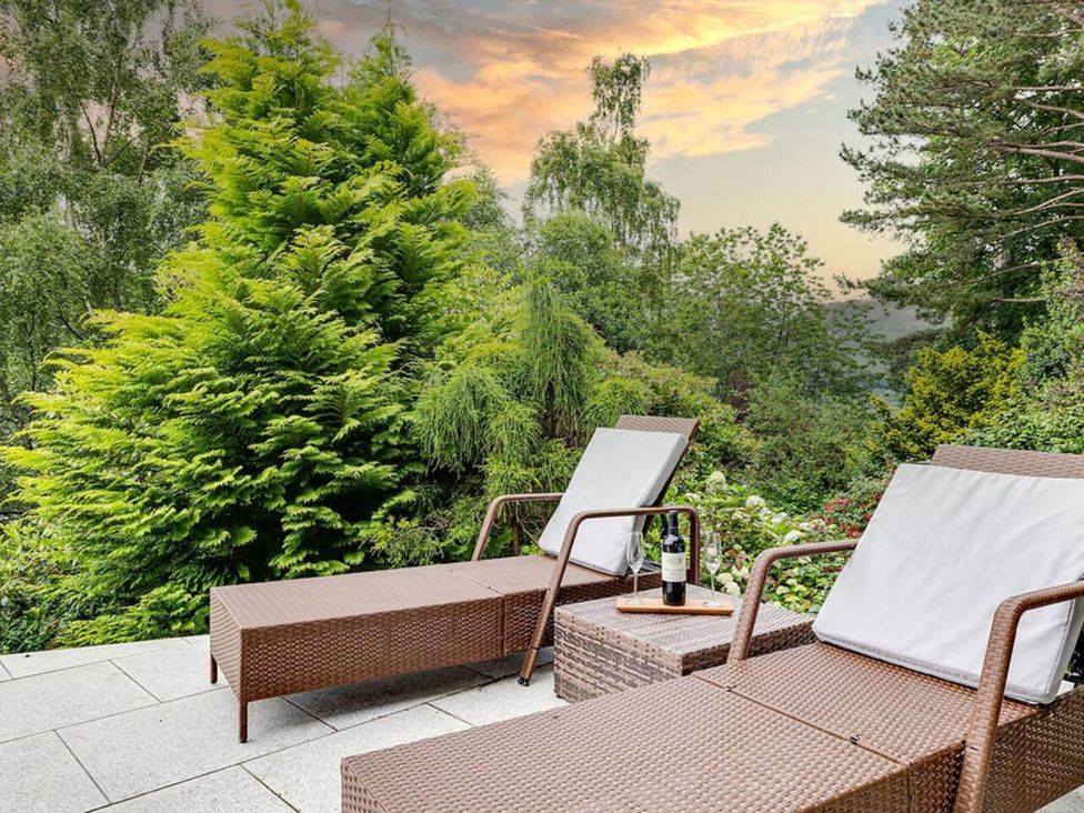 A garden with sun loungers and a table at tbc 