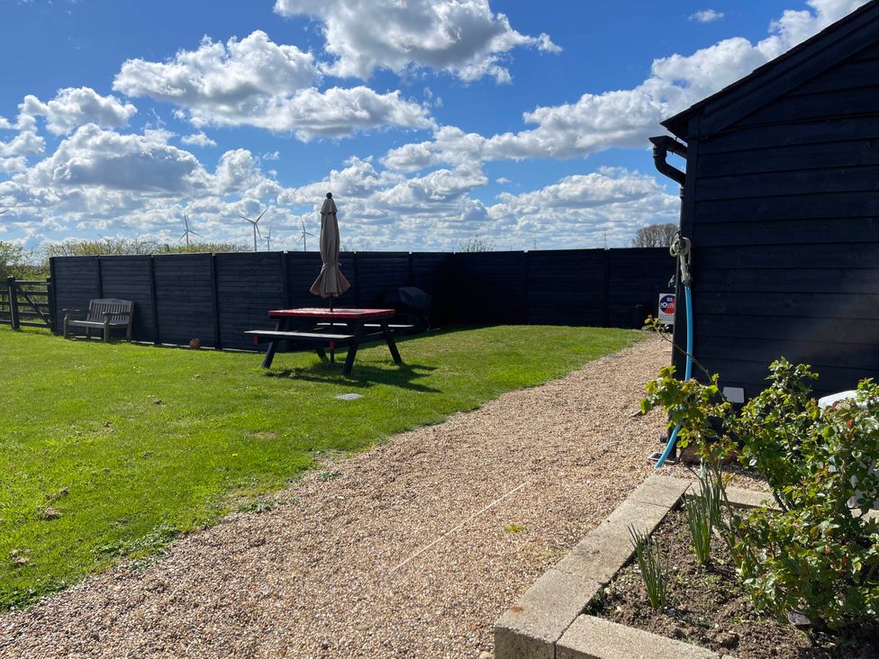 A garden with seating and a gravel path at tbc