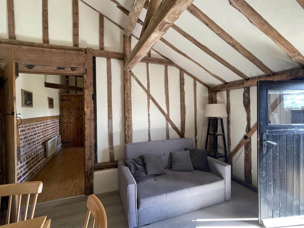 A living room with a sofa and lamp at tbc in 