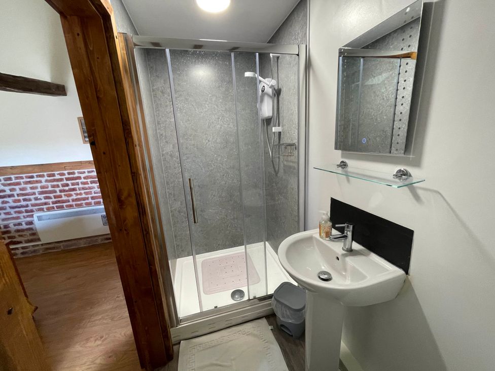 A bathroom with a shower and sink at tbc in 