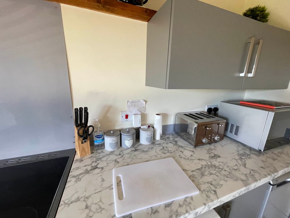 A kitchen with countertop appliances and utensils at tbc 