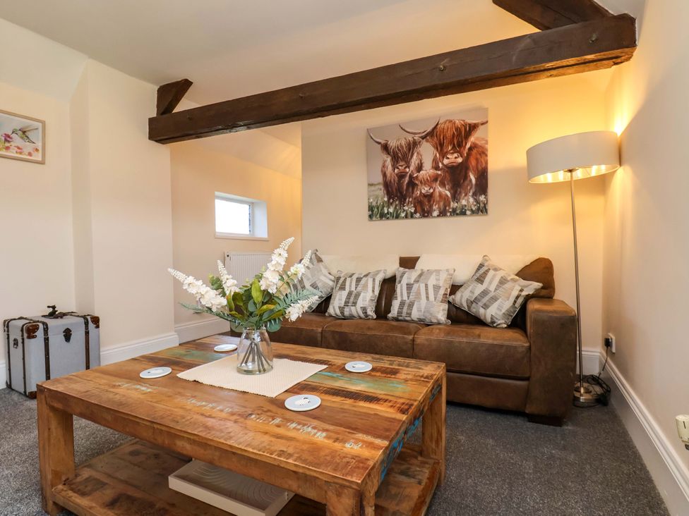 A living room with a sofa and coffee table at Lamb Cottage Stockton-On-Tees