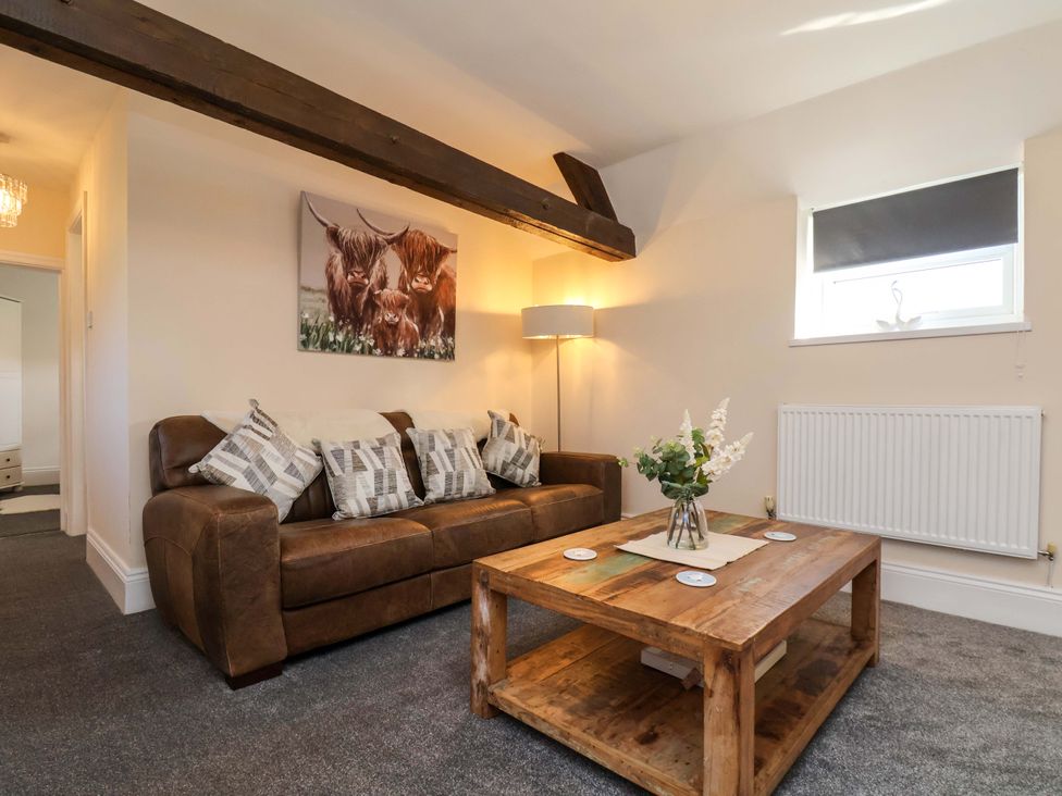 A living room with a sofa and coffee table at Lamb Cottage Stockton-On-Tees