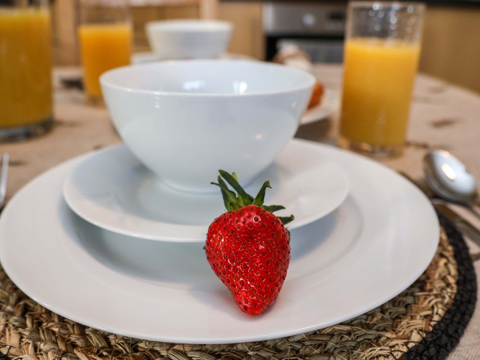 A bowl on a plate with a strawberry at Lamb Cottage Stockton-On-Tees