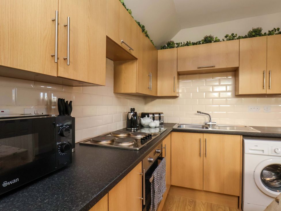 A kitchen with cabinets and appliances at Lamb Cottage Stockton-On-Tees