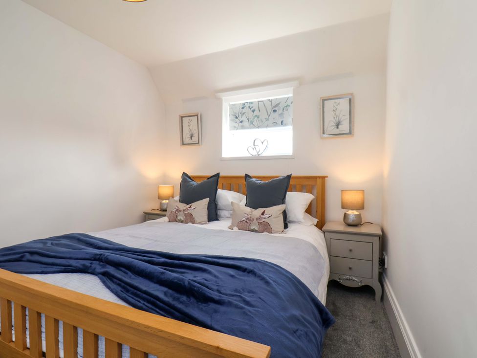 A bedroom with a bed and bedside tables at Lamb Cottage Stockton-On-Tees