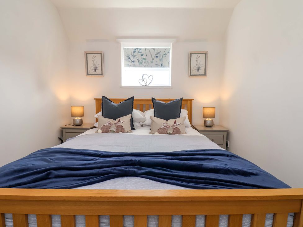 A bedroom with a bed and nightstands at Lamb Cottage Stockton-On-Tees