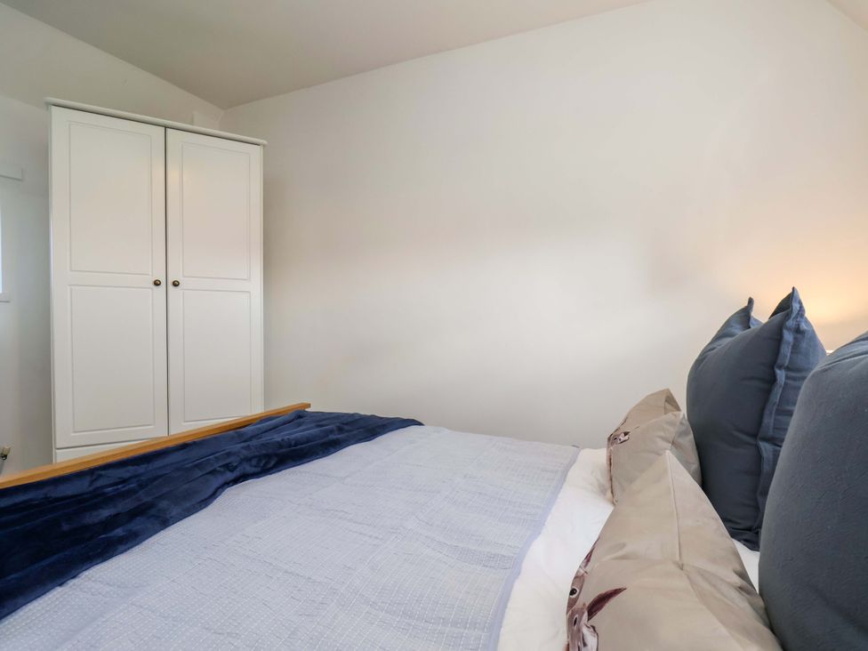 A bedroom with a bed and wardrobe at Lamb Cottage Stockton-On-Tees