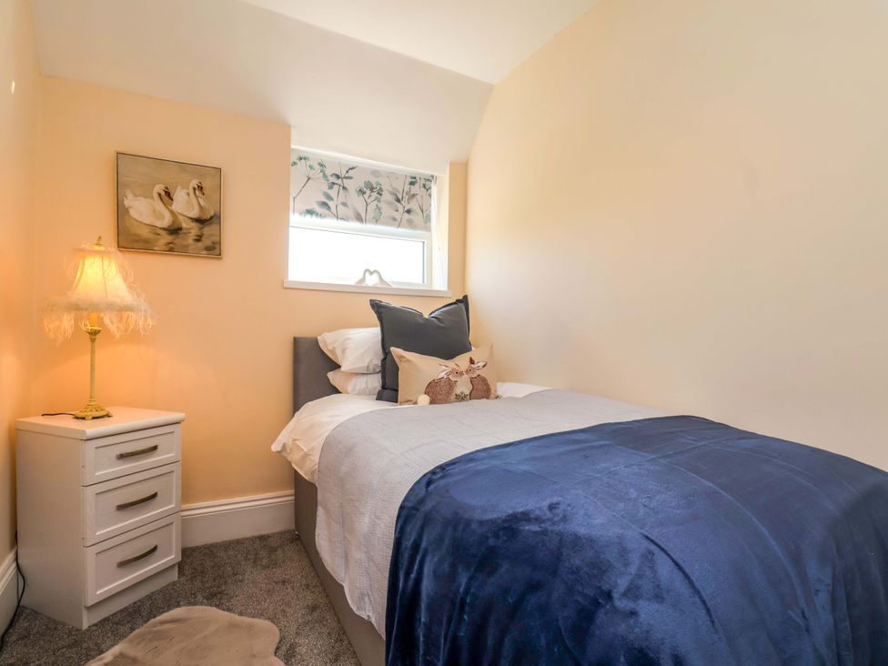A bedroom with a bed and bedside table at Lamb Cottage Stockton-On-Tees