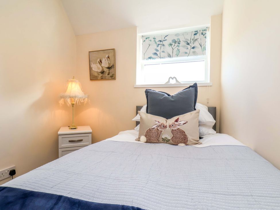 A bedroom with a bed and bedside table at Lamb Cottage Stockton-On-Tees