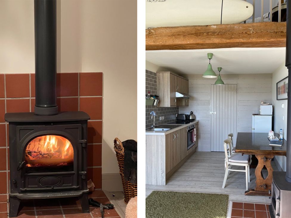 A wood stove and kitchen setup at tbc 