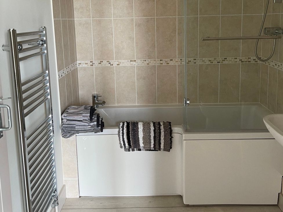 A bathroom with a bathtub and towels at tbc in 