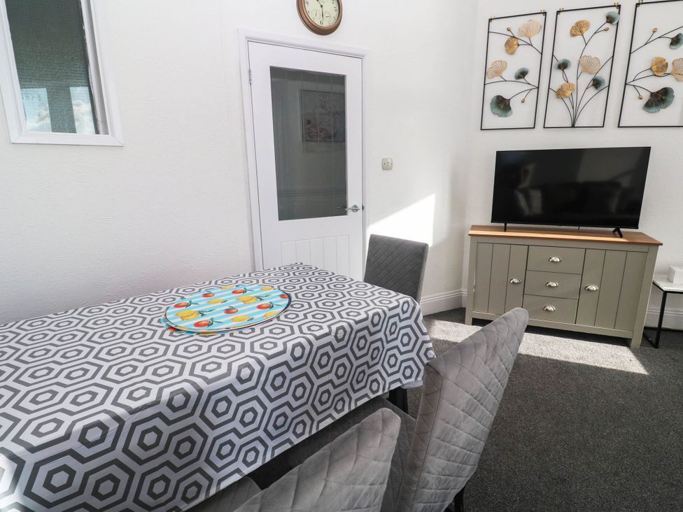 A dining room with a table and chairs at Flat 2 in Penzance
